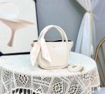 Premium leather handbag with a silk scarf wrapped around the handle and a matching crossbody strap