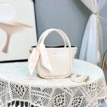 Premium leather handbag with a silk scarf wrapped around the handle and a matching crossbody strap