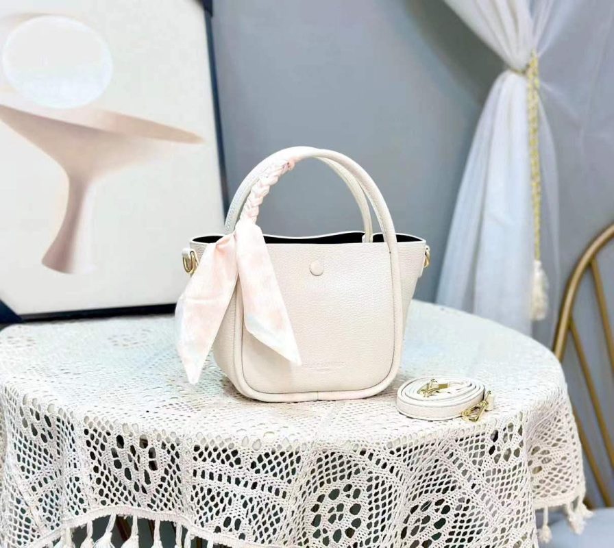Premium leather handbag with a silk scarf wrapped around the handle and a matching crossbody strap